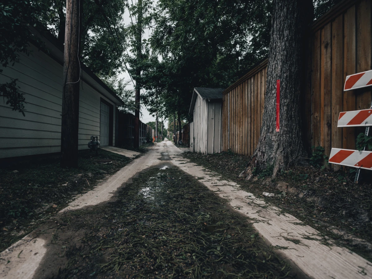 Narrow side access between a beachside house and its boundary fence