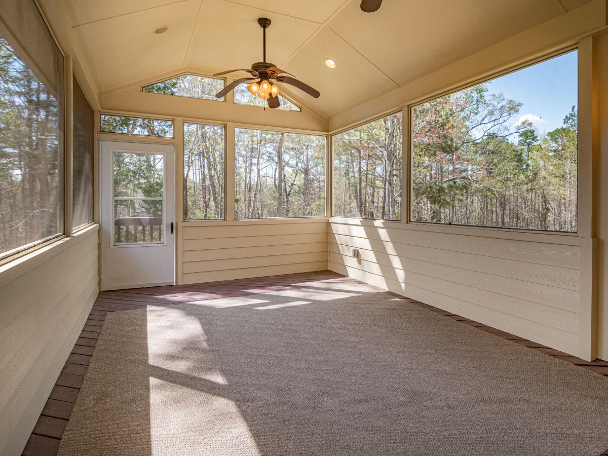 Tree growing close to a screened back porch
