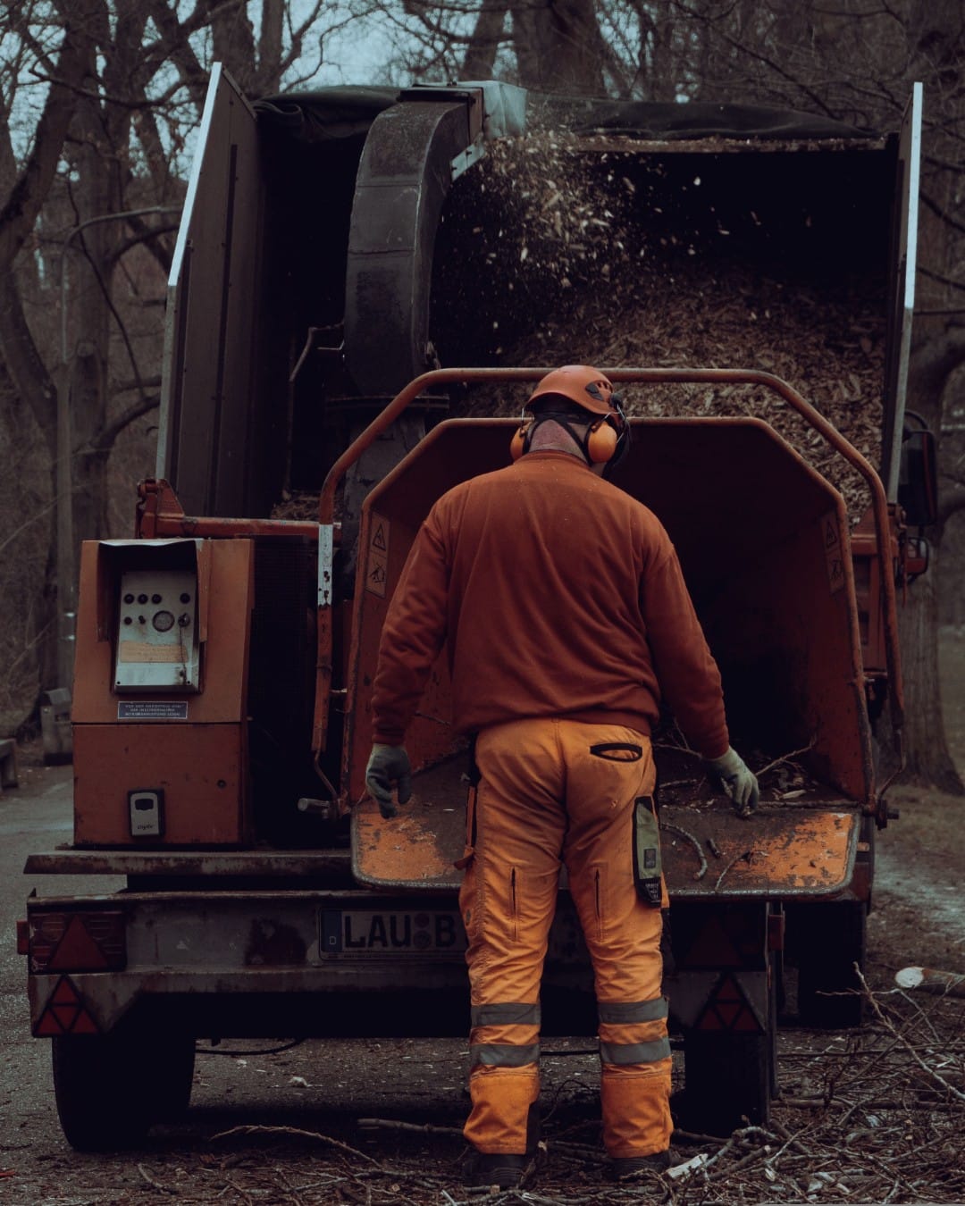 Wood chipper blowing chips into a truck bed
